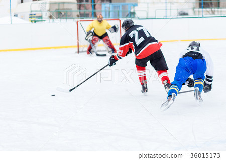 Young skater man in attack. Ice hockey game 36015173