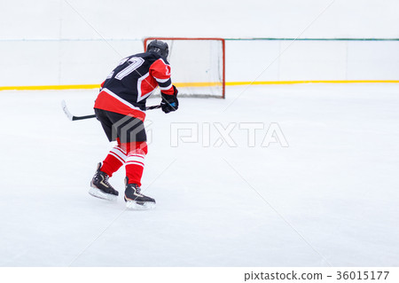 Ice hockey skater with stick on rink Ice hockey skater with stick on rink 36015177
