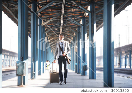 Mature businessman on a train station. Mature businessman on a train station. 36015890