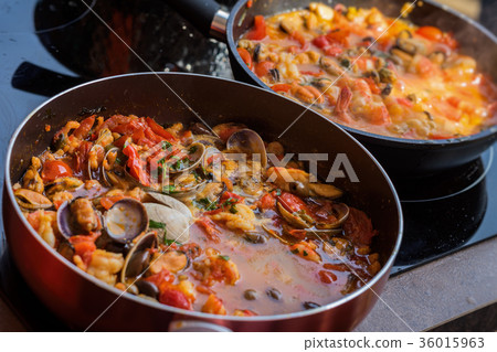Close-up of frying pans with seafood dish cooked Close-up of frying pans with seafood dish cooked 36015963