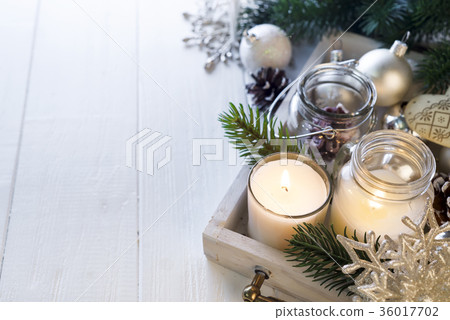 Burning candle and Christmas decoration Burning candle and Christmas decoration 36017702
