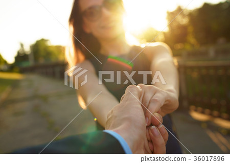 Follow me - happy young woman pulling guy's hand Follow me - happy young woman pulling guy's hand 36017896