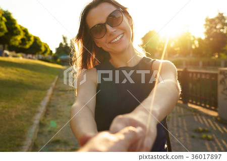 Follow me - happy young woman pulling guy's hand Follow me - happy young woman pulling guy's hand 36017897