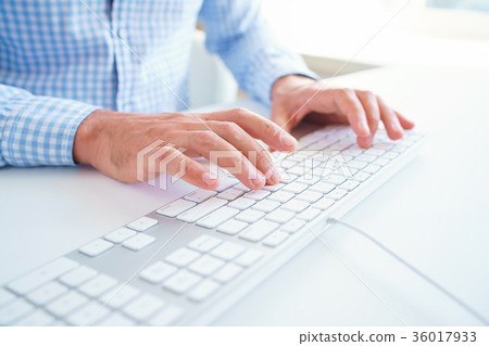 Men office worker typing on the keyboard Men office worker typing on the keyboard 36017933