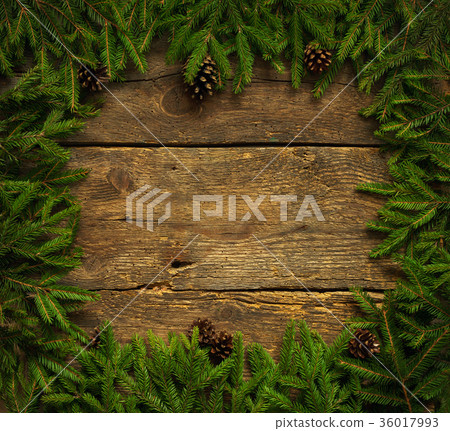 Christmas tree branches with cones on wood texture Christmas tree branches with cones on wood texture 36017993