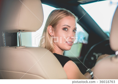 Beautiful young woman on driving seat in new car. Beautiful young woman on driving seat in new car. 36018763
