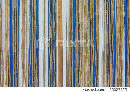 Colorful bamboo fence on wood texture Colorful bamboo fence on wood texture 36027355