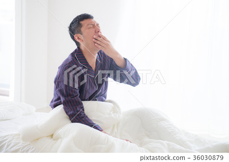Young man getting up and yawning 36030879