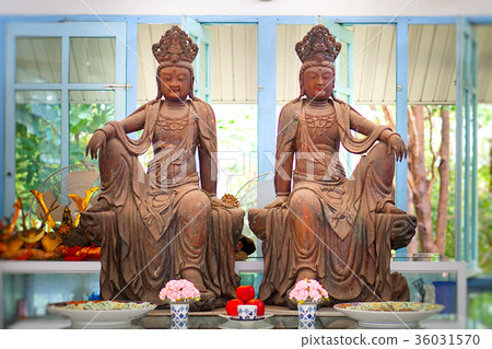 Kuan Yin image of buddha , Wood carving in a thai Kuan Yin image of buddha , Wood carving in a thai 36031570