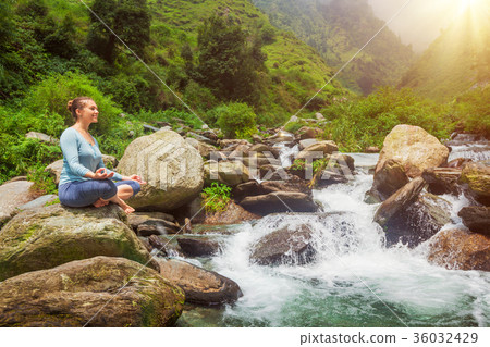 Woman in Padmasana outdoors 36032429