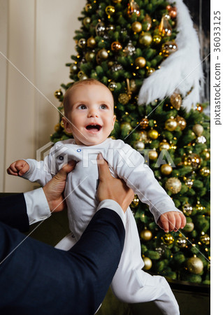 Father and child play Christmas. Dad holds a boy Father and child play Christmas. Dad holds a boy 36033125