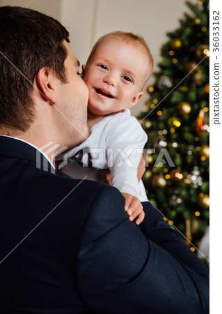 Father and child play Christmas. Dad holds a boy Father and child play Christmas. Dad holds a boy 36033162