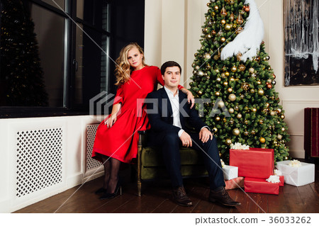 Portrait of a beautiful couple on a christmas tree Portrait of a beautiful couple on a christmas tree 36033262