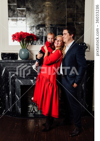 Young happy family with a baby indoors Young happy family with a baby indoors 36033286