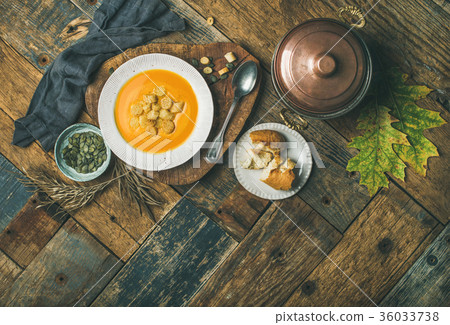 Fall pumpkin cream soup with croutons and seeds 36033738