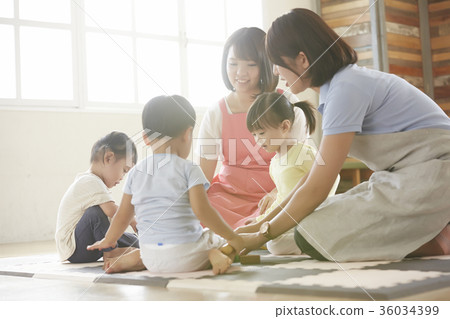 Nursery teacher and children playing 36034399