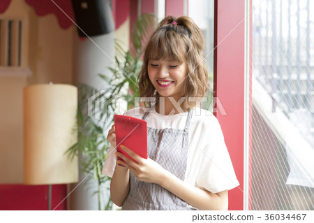 A woman working in a cafe 36034467