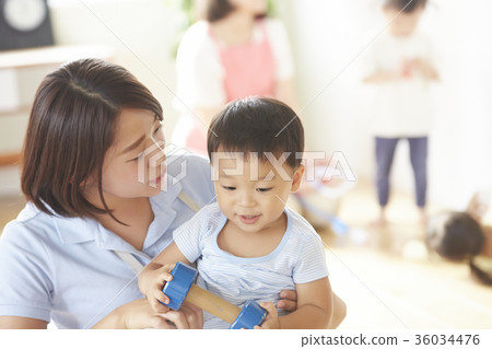 Nursery teacher and children playing Nursery teacher and children playing 36034476