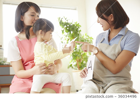 Nursery teacher and children studying Nursery teacher and children studying 36034496