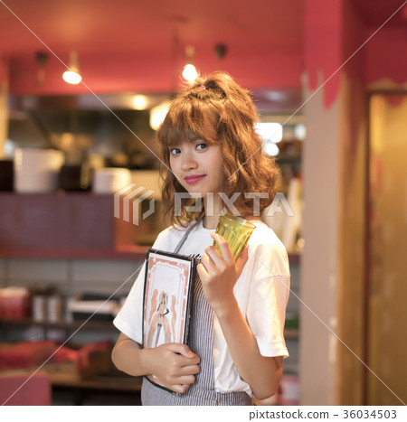A woman working in a cafe 36034503