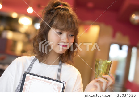 A woman working in a cafe A woman working in a cafe 36034539