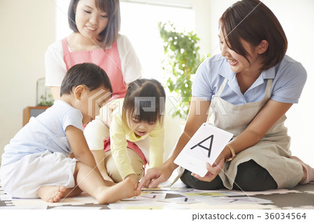Nursery teacher and children studying 36034564