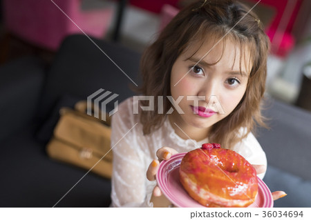A woman relaxing at a cafe A woman relaxing at a cafe 36034694