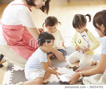 Nursery teacher and children studying Nursery teacher and children studying 36034701