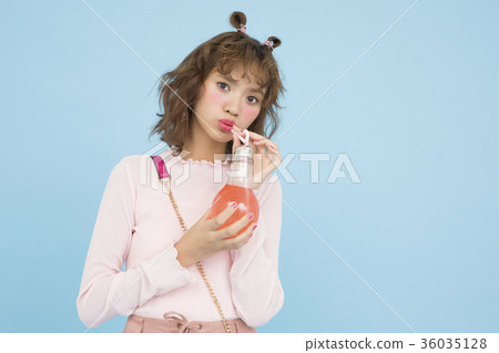 A woman drinking a drink 36035128