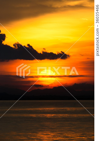 Sunset at the lake with dark cloud. 36035466
