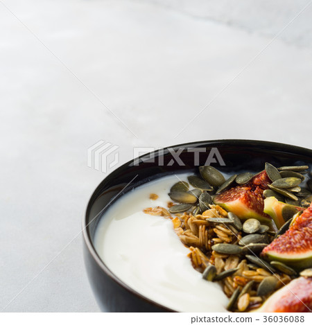 Healthy breakfast yogurt bowl with granola and fig 36036088
