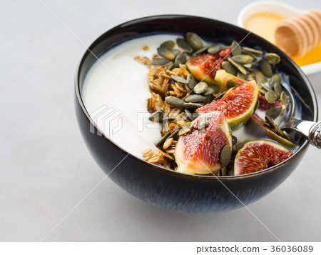 Healthy breakfast yogurt bowl with granola and fig 36036089