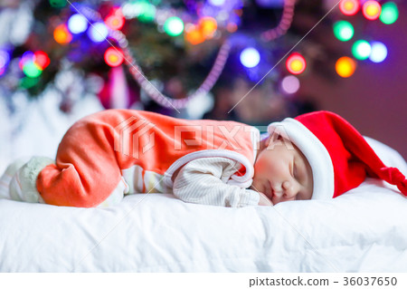One week old newborn baby in Santa hat near 36037650