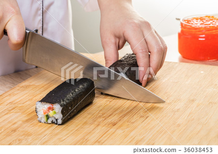 Chef cuts rolls, hands close-up Chef cuts rolls, hands close-up 36038453