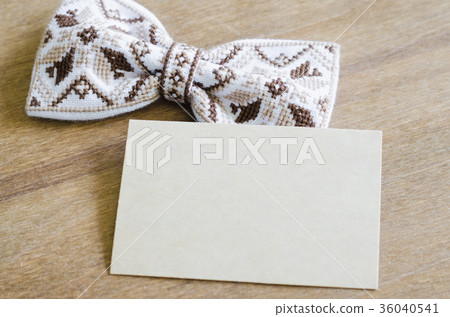 Bow Tie and Empty Card on Wooden Background. Bow Tie and Empty Card on Wooden Background. 36040541