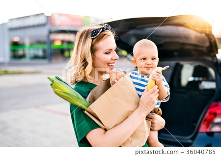 Young mother with baby boy in front of a 36040785