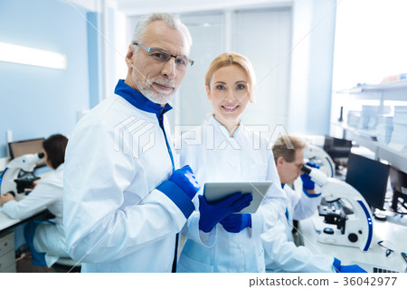 Smiling biologists discussing gene research Smiling biologists discussing gene research 36042977