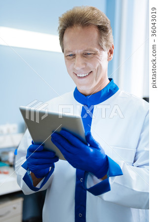 Smiling young scientist holding a tablet 36043019