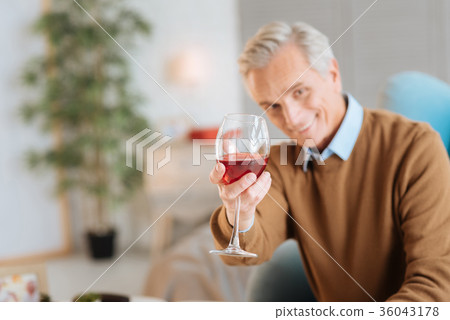 Happy old man enjoying his glass of red wine Happy old man enjoying his glass of red wine 36043178