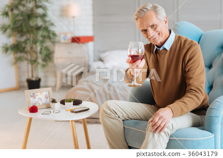 Joyful senior gentleman with glass of wine smiling Joyful senior gentleman with glass of wine smiling 36043179