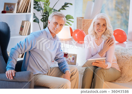 Joyful retired husband and wife relaxing at home Joyful retired husband and wife relaxing at home 36043586
