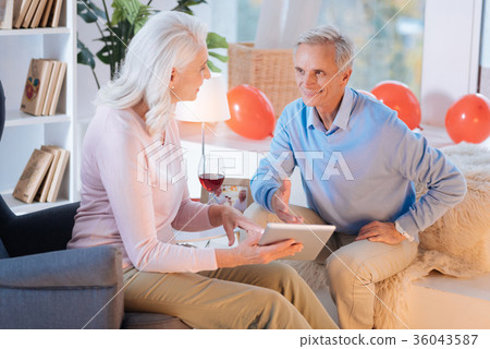 Smiling senior couple discussing something on Smiling senior couple discussing something on 36043587