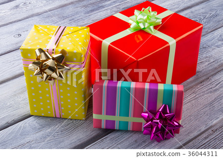 Cute gift boxes on wooden background. 36044311