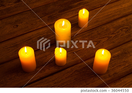 Candles on old wooden background. 36044550