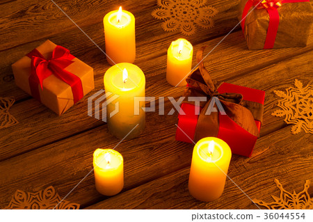 New Year gifts with candles and snowflakes. New Year gifts with candles and snowflakes. 36044554