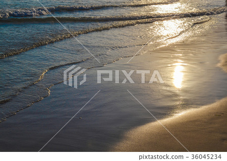 Evening calm waves in the sand.   36045234