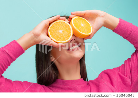 Beautiful woman's face with juicy orange 36046045