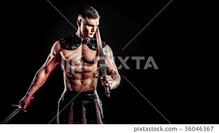 Severe barbarian in leather costume with sword Severe barbarian in leather costume with sword 36046367