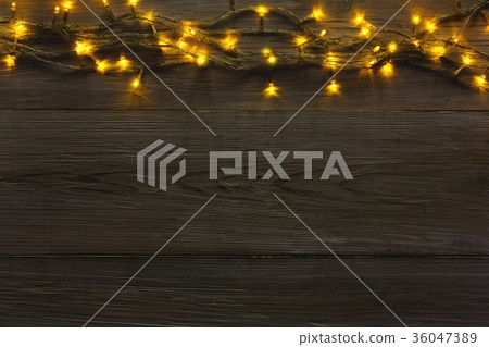 Christmas lights border on grey wooden background 36047389