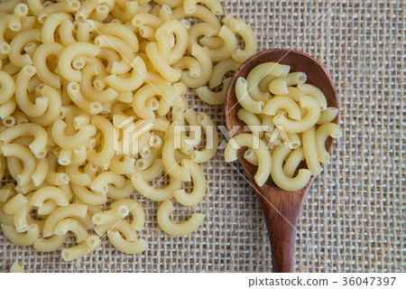 Macaroni Raw pasta in wooden spoon on sack rustic 36047397